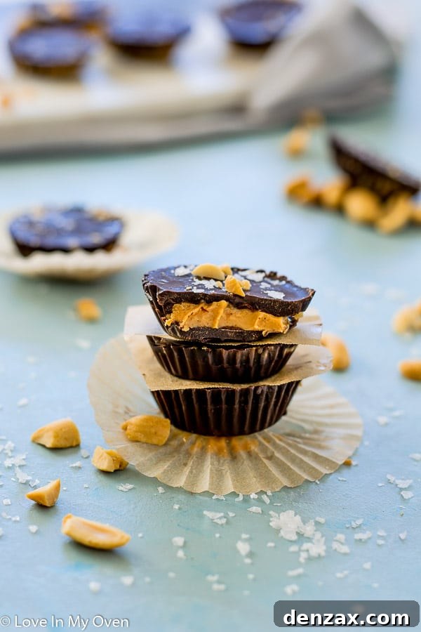 Stack of dark chocolate mini peanut butter cups with sea salt flakes