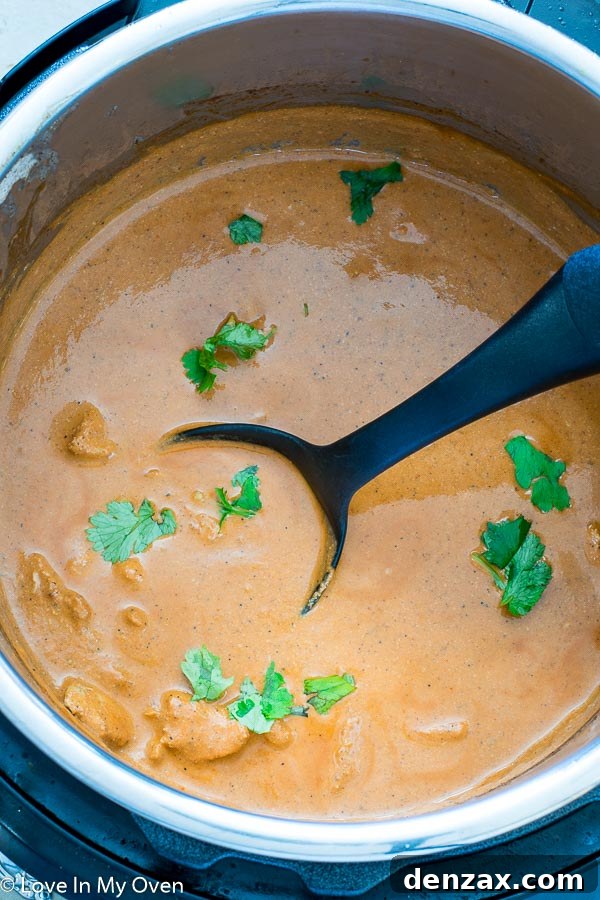 A close-up of creamy Instant Pot Chicken Tikka Masala in a bowl, garnished with fresh cilantro.