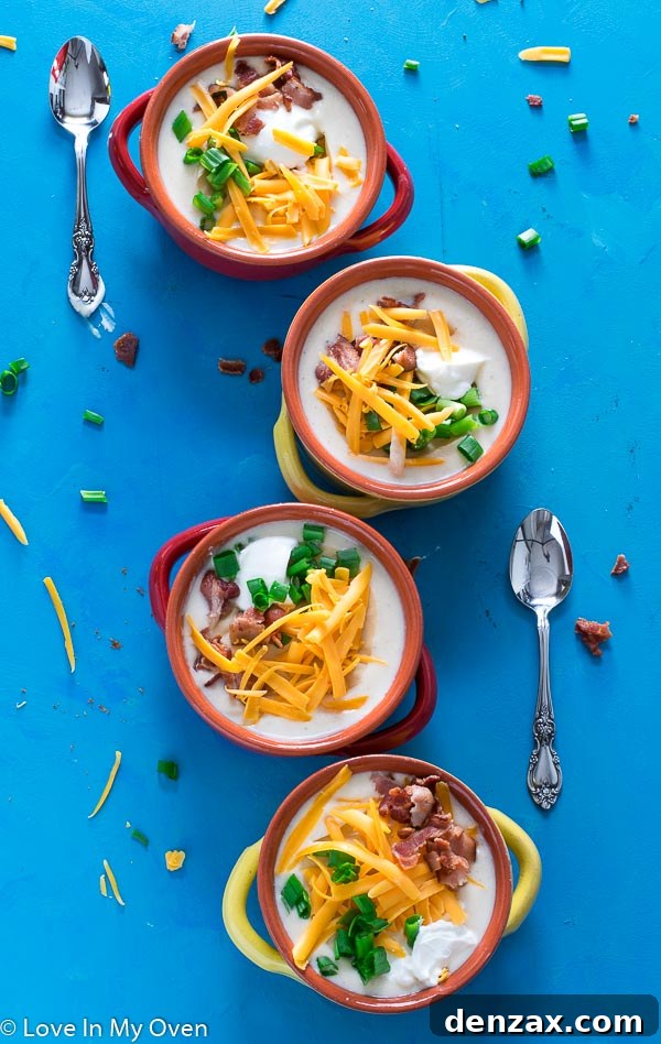A bowl of creamy Instant Pot Loaded Cauliflower Soup, garnished with bacon and chives.