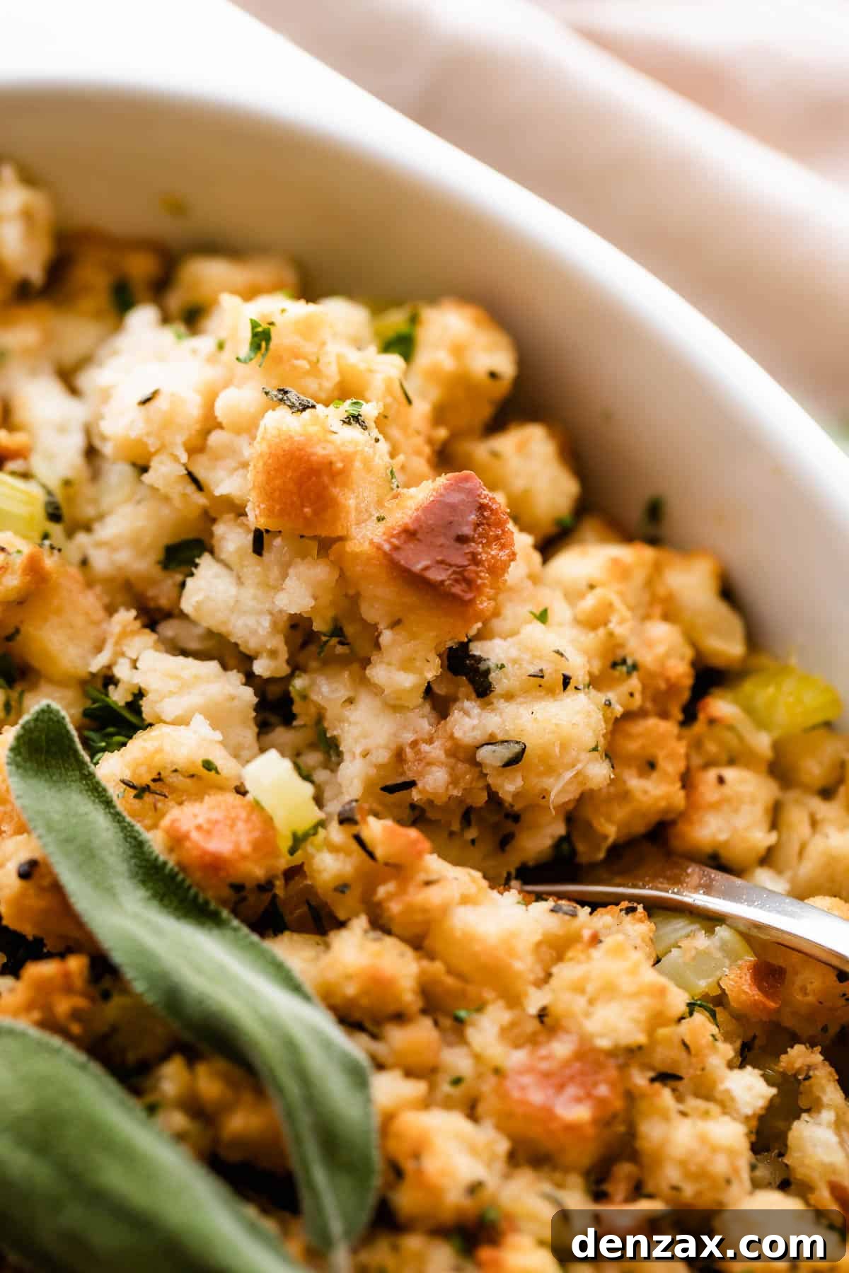 A close-up shot revealing the delightful texture of the golden-brown herb stuffing, showcasing individual toasted bread cubes infused with herbs and vegetables.