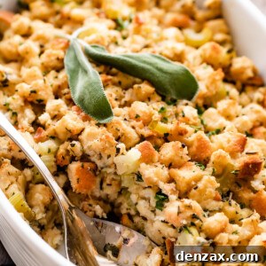 An overhead shot of a golden-brown scalloped casserole dish, generously filled with freshly baked bread stuffing. A serving spoon rests invitingly in the dish, ready for serving.