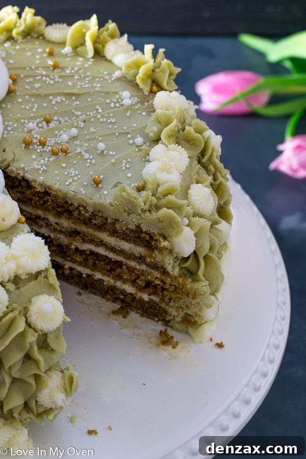 A slice of Matcha Vanilla Cake on a white plate, highlighting its layers and moist texture.