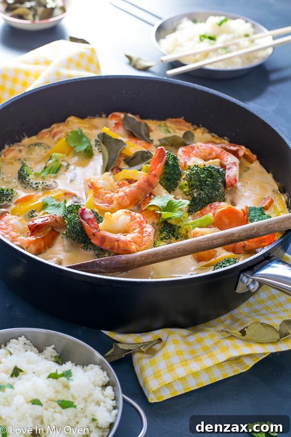 red thai prawn curry cooking in a pan