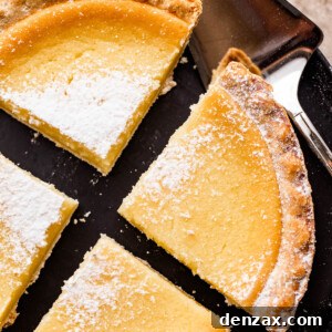 overhead shot of buttermilk pie cut into 4 slices and dusted with powdered sugar.