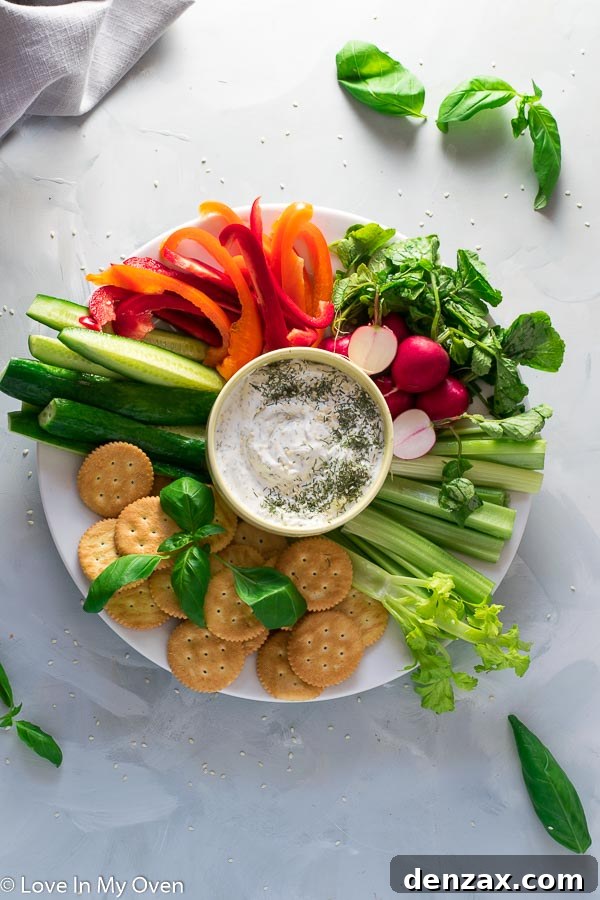 A delicious creamy ranch dip served in a rustic bowl, garnished with fresh herbs, surrounded by colorful vegetables for dipping, set against a bright, welcoming background, evoking spring gatherings and healthy snacking.