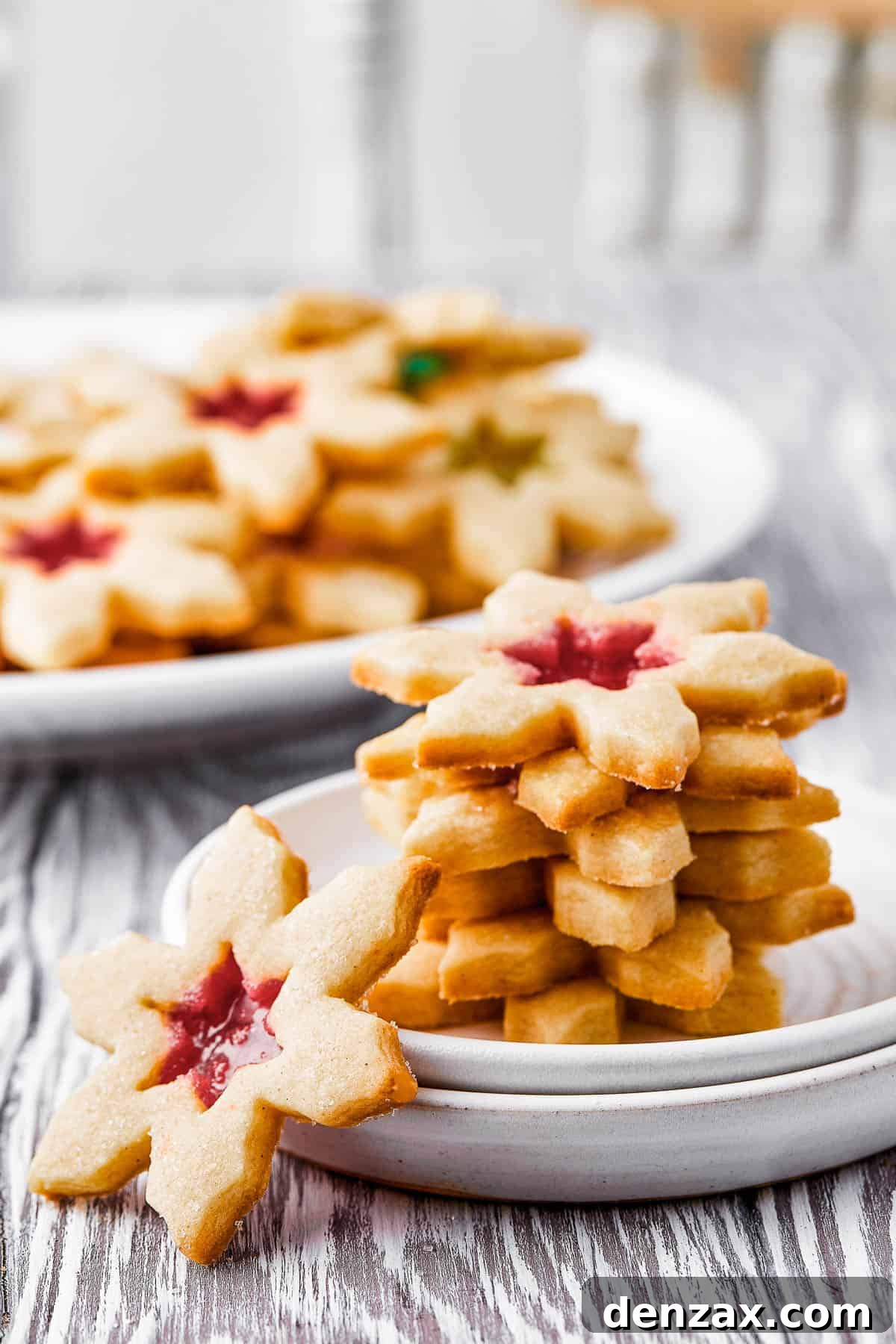 A platter of cookies, with five cookies stacked on a small plate nearby. One cookie is offset, leaning against the small plate.