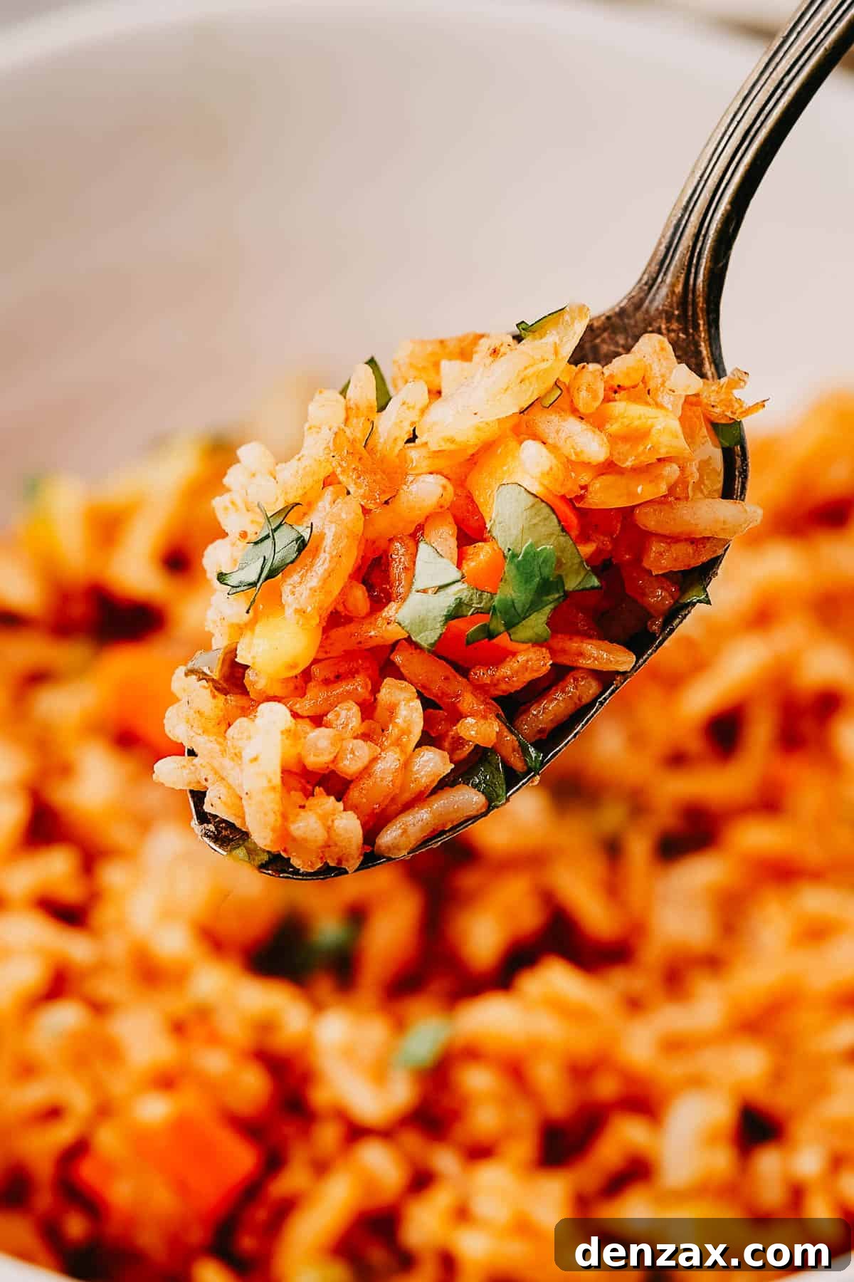 Instant Pot Fiesta Rice 10 A spoon lifting a bite of rice out of a bowl.