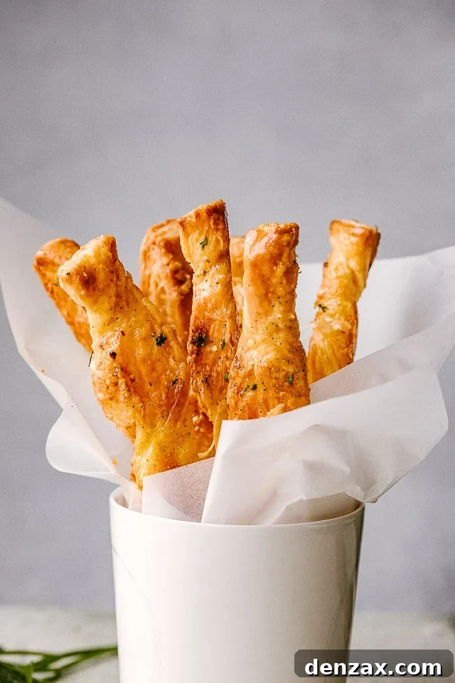 Puff Pastry sticks ready to serve in a white cup.