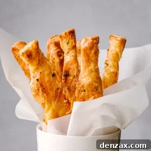 Puff Pastry sticks ready to serve in a white cup.