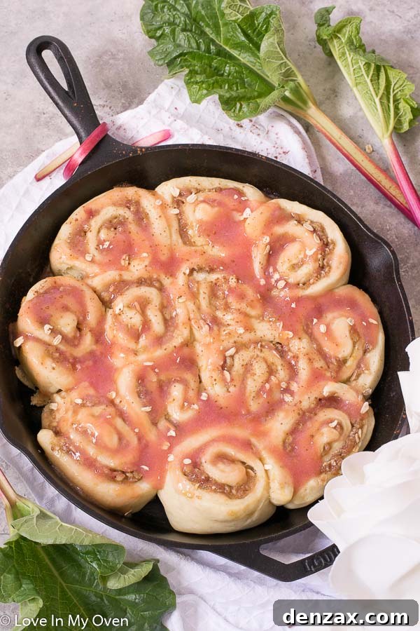 Close-up of freshly baked Rhubarb Streusel Rolls with ruby red compote peeking through
