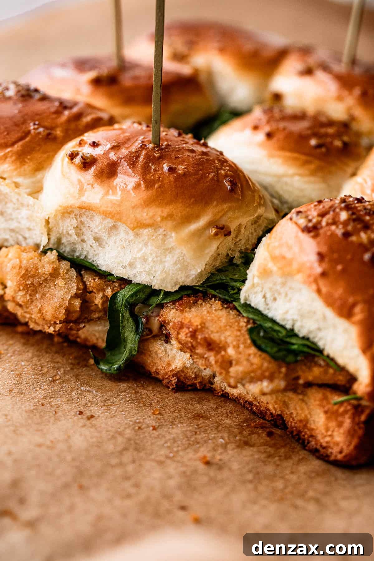 Crab cakes perfectly sandwiched between golden-brown Hawaiian rolls, showcasing the completed sliders.