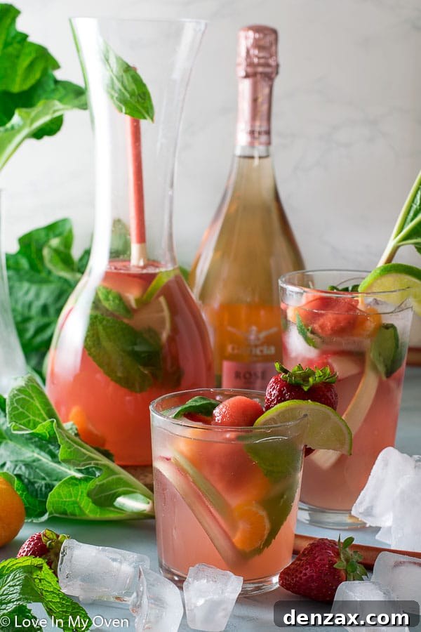 Glass of Rhubarb Rosé Sangria with frozen fruit
