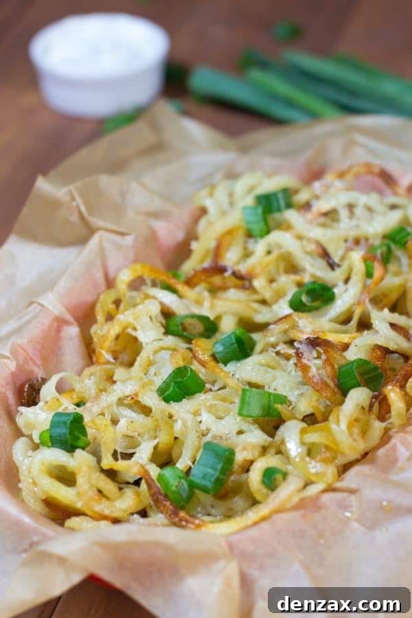 Oven Baked Curly Cheese Fries, golden and covered with melted cheese.