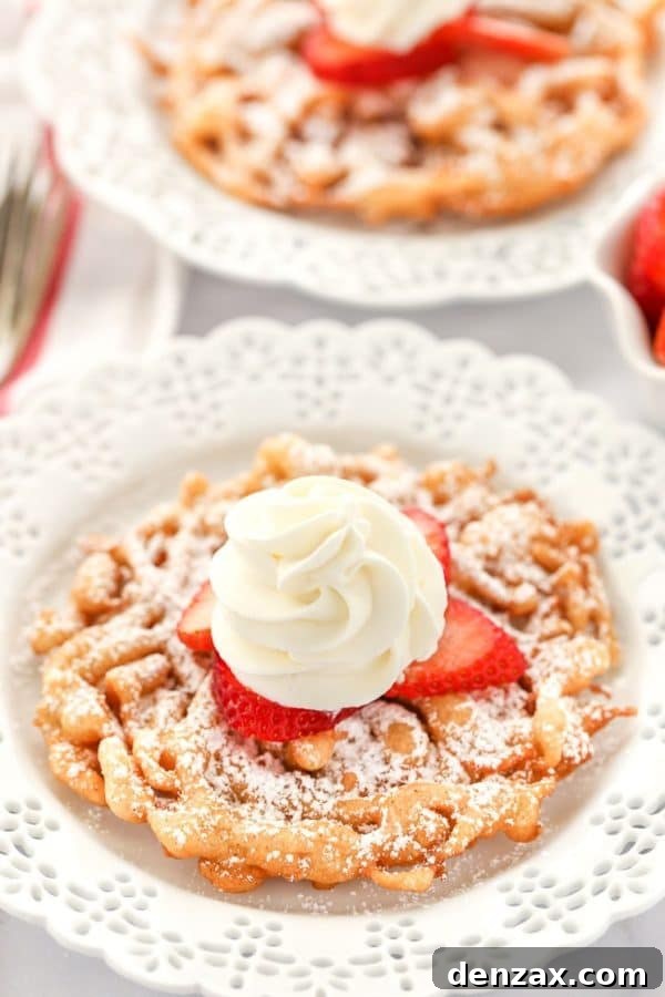 Classic Homemade Funnel Cake, golden brown and dusted with powdered sugar.