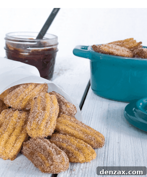 Easy Baked Churro Bites, served with a rich chocolate sauce.