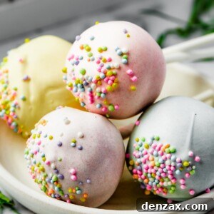 Pastel cake pop lollipops on a white plate, ready to be enjoyed.