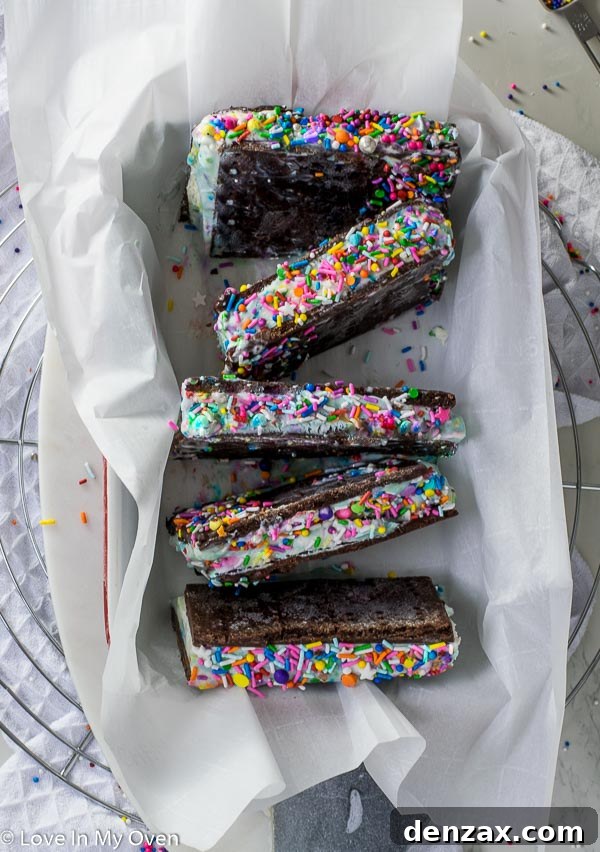 Hand holding a slice of birthday cake ice cream sandwich