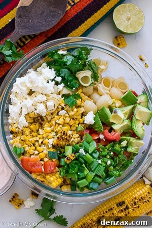 Two side-by-side servings of Mexican Street Corn Pasta Salad, showcasing fresh cilantro and creamy dressing