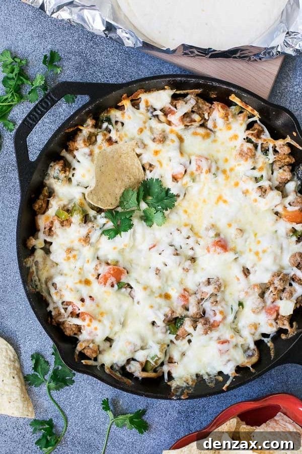 Close-up of Queso Fundido with Chorizo bubbling in a cast iron skillet