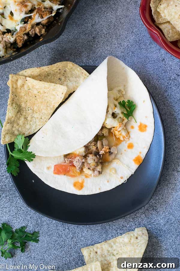 A large serving of Queso Fundido with Chorizo on a table, ready to be enjoyed