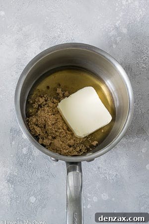 Individual M&M Granola Bar portions being pressed into a baking dish