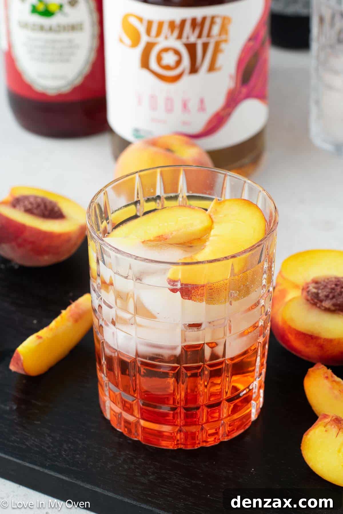 peach vodka cocktail with fresh peaches and lime