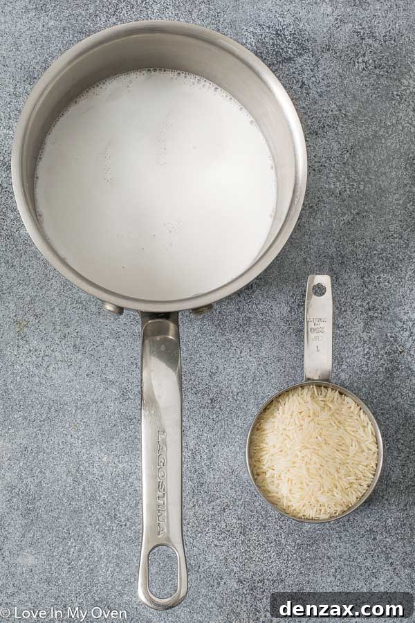 Creamy Easy Coconut Rice cooking in a saucepan, ready to be fluffed and served