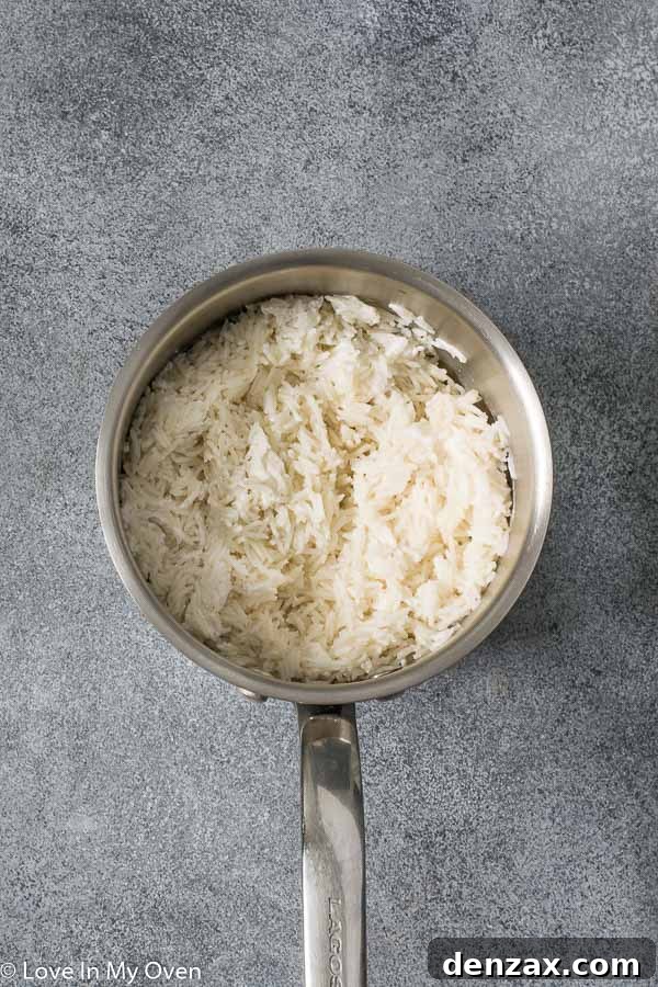 Fluffy easy coconut rice in a saucepan, ready to be served