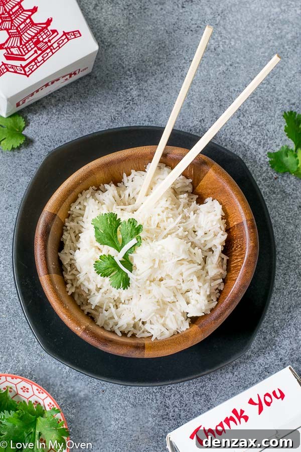 Serving bowl of fluffy easy coconut rice with fresh herbs