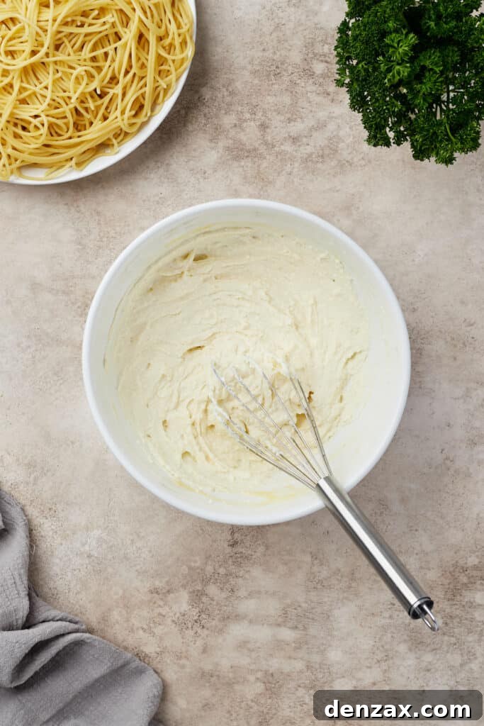 Ricotta and egg whisked together in a mixing bowl.