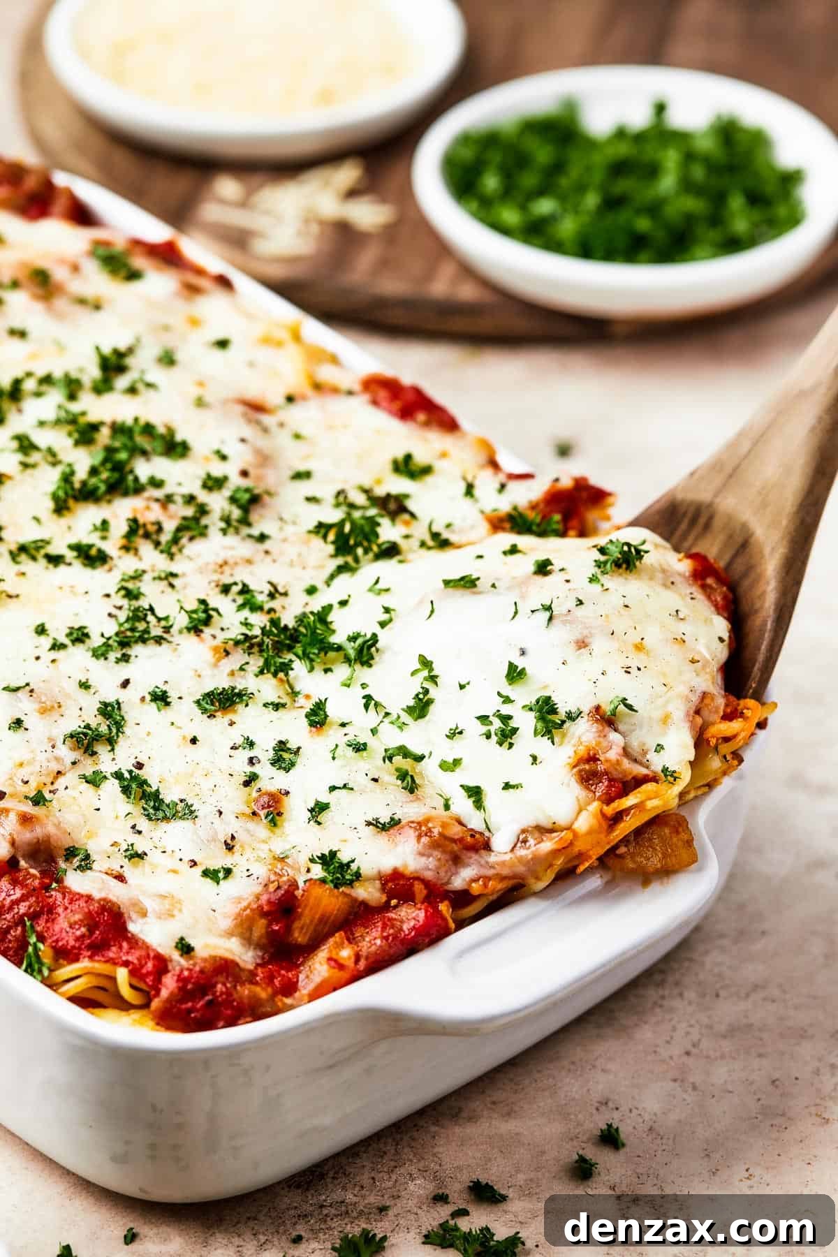 Spaghetti casserole in a white baking dish.
