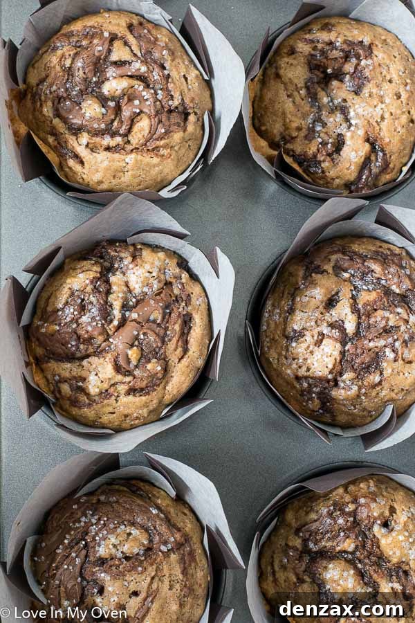 Beautifully baked Nutella swirl muffins with a golden-brown top, ready to be enjoyed.
