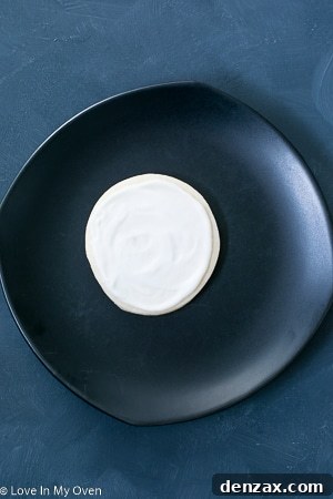 Step-by-step image showing black dots and concentric circles piped onto wet white icing.