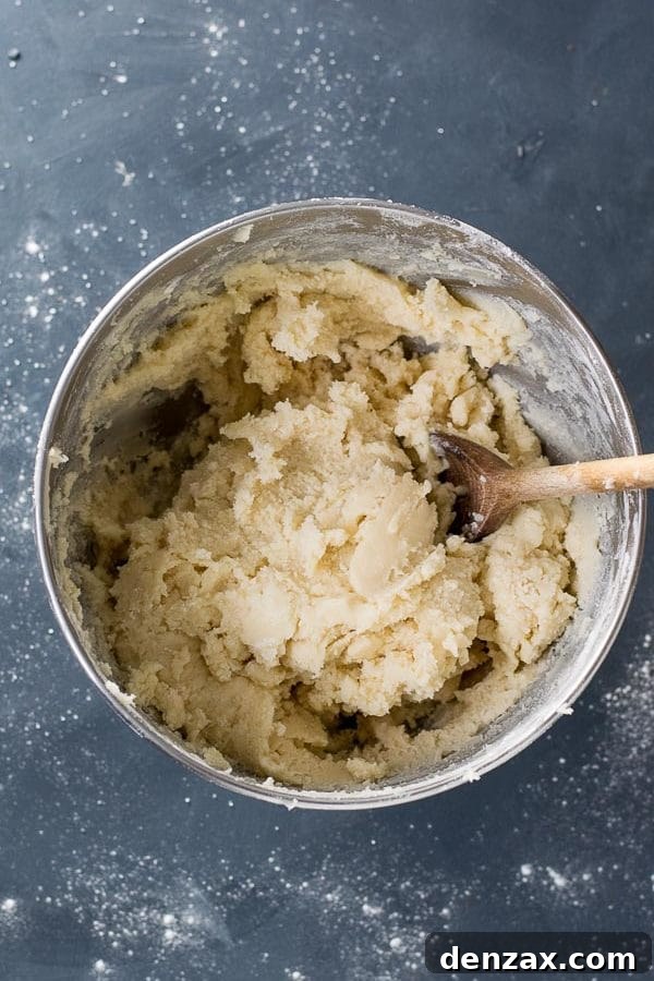 Mixing cookie dough in a stand mixer, showing the creamy texture before chilling.