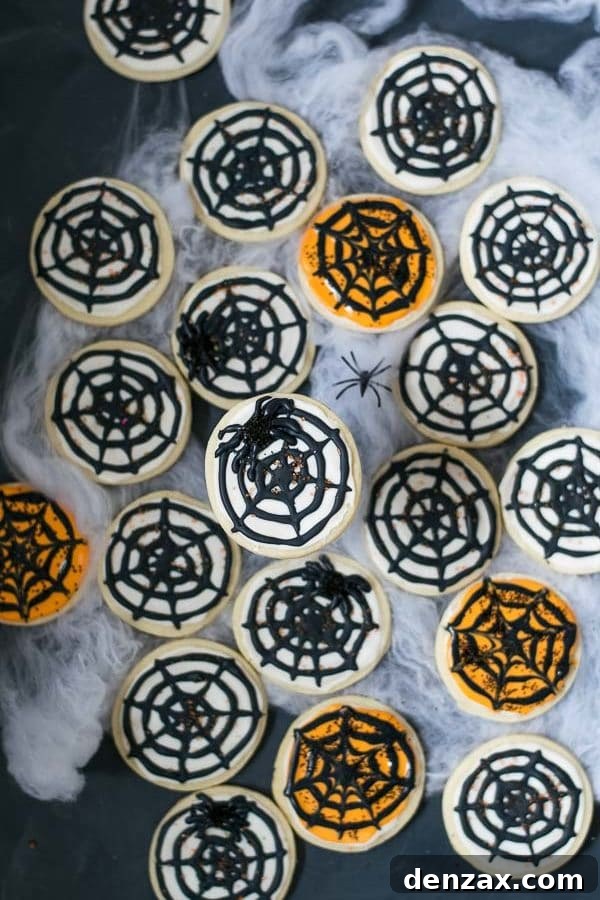 A completed cream cheese spiderweb cookie, intricately decorated with black and white royal icing, resting on a serving platter.