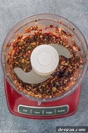 Cranberry chicken thighs marinating in a sealed bag.