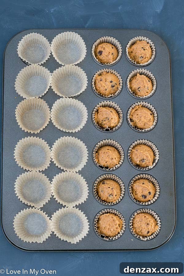 Mini pumpkin muffin batter in baking tin