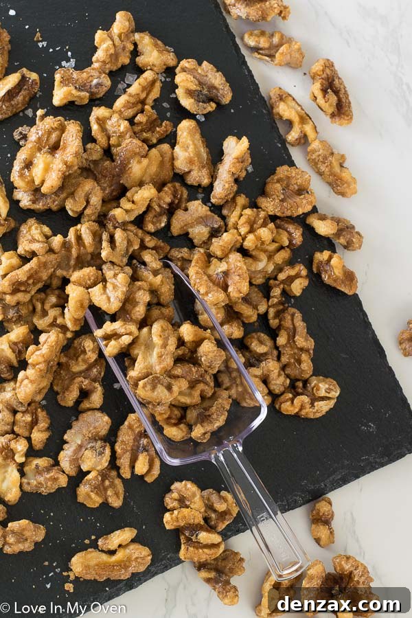 Freshly baked healthy candied walnuts cooling on parchment paper.