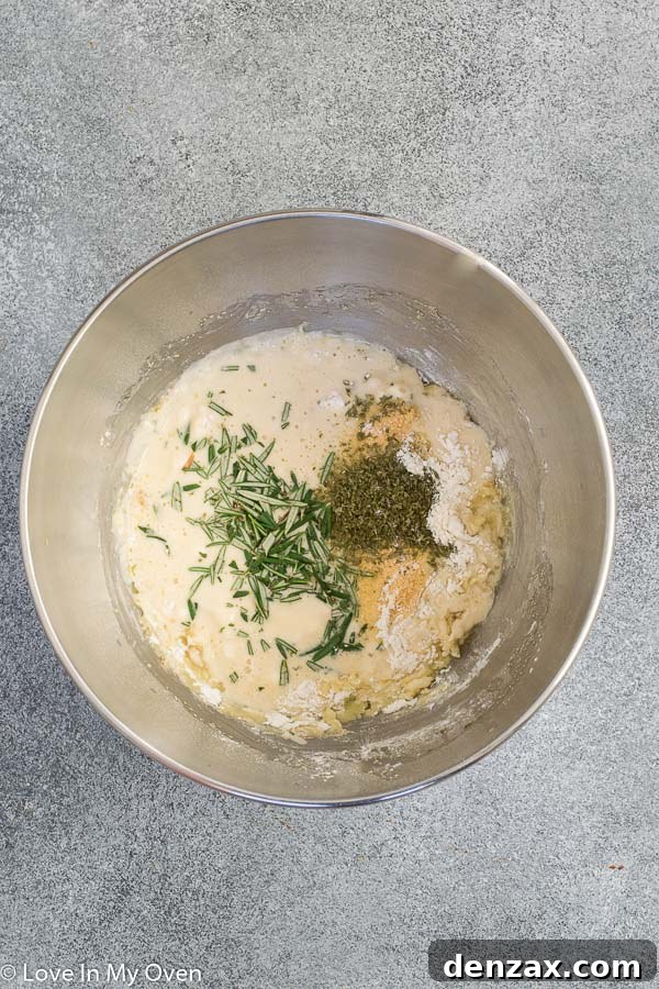 Mixing the dough for quick dinner rolls in a stand mixer, showing the early stages of combination.
