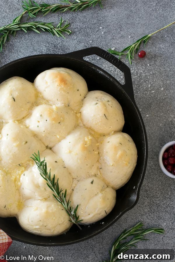 A basket of freshly baked 30-minute dinner rolls with rosemary and garlic butter, ready for the table.