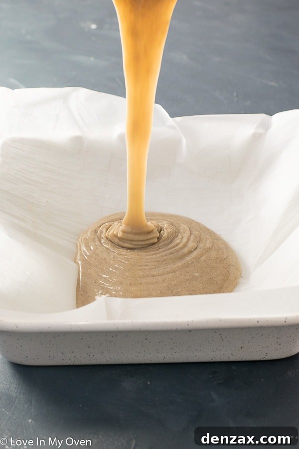 Gingerbread fudge cooling in a foil-lined baking pan, a clear visual of the setting process.