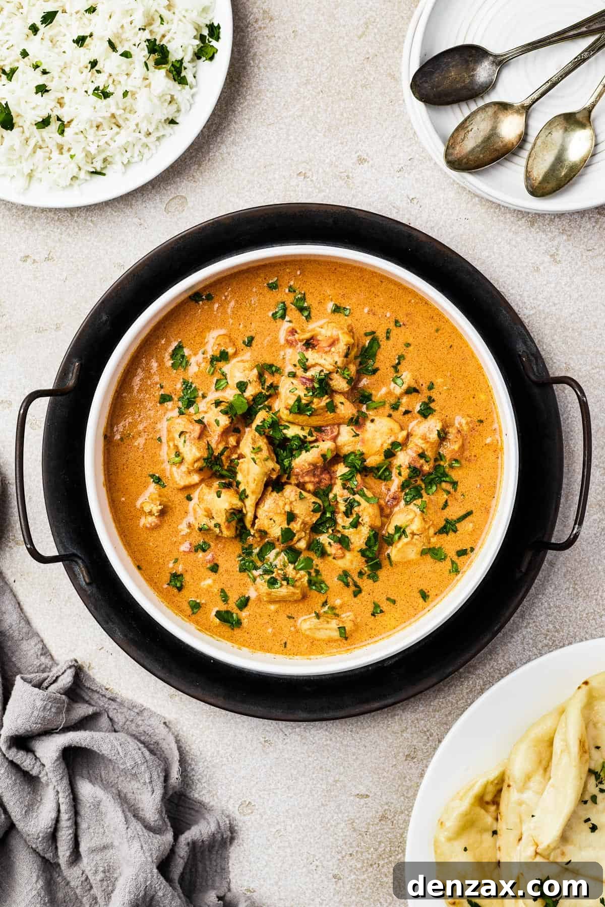 Butter Chicken Makhani 9 Overhead view of Indian Butter Chicken served in a white dish, ready to eat.