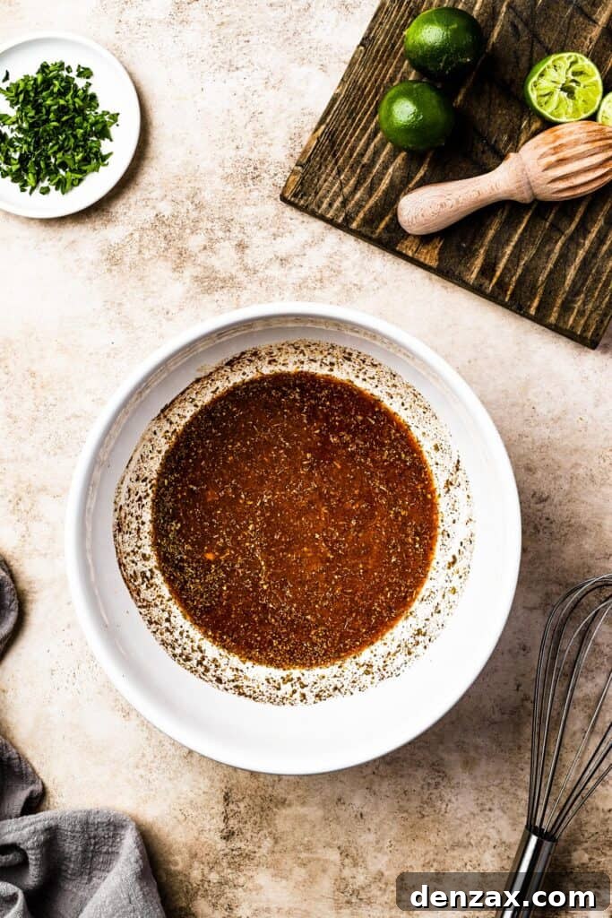 A vibrant citrus and spice mixture in a white bowl, ready for the pork.
