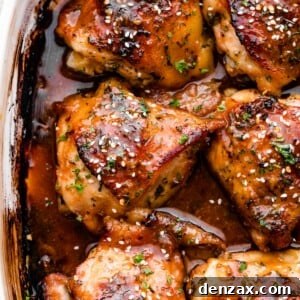 Overhead shot of honey garlic baked chicken thighs garnished with sesame seeds.