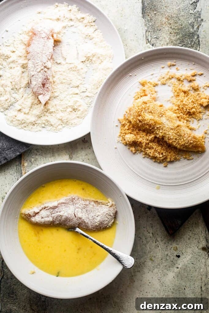 A collage of three bowls showing the breading process: raw chicken tender in whisked eggs, in all-purpose flour, and coated in pork rind breading.