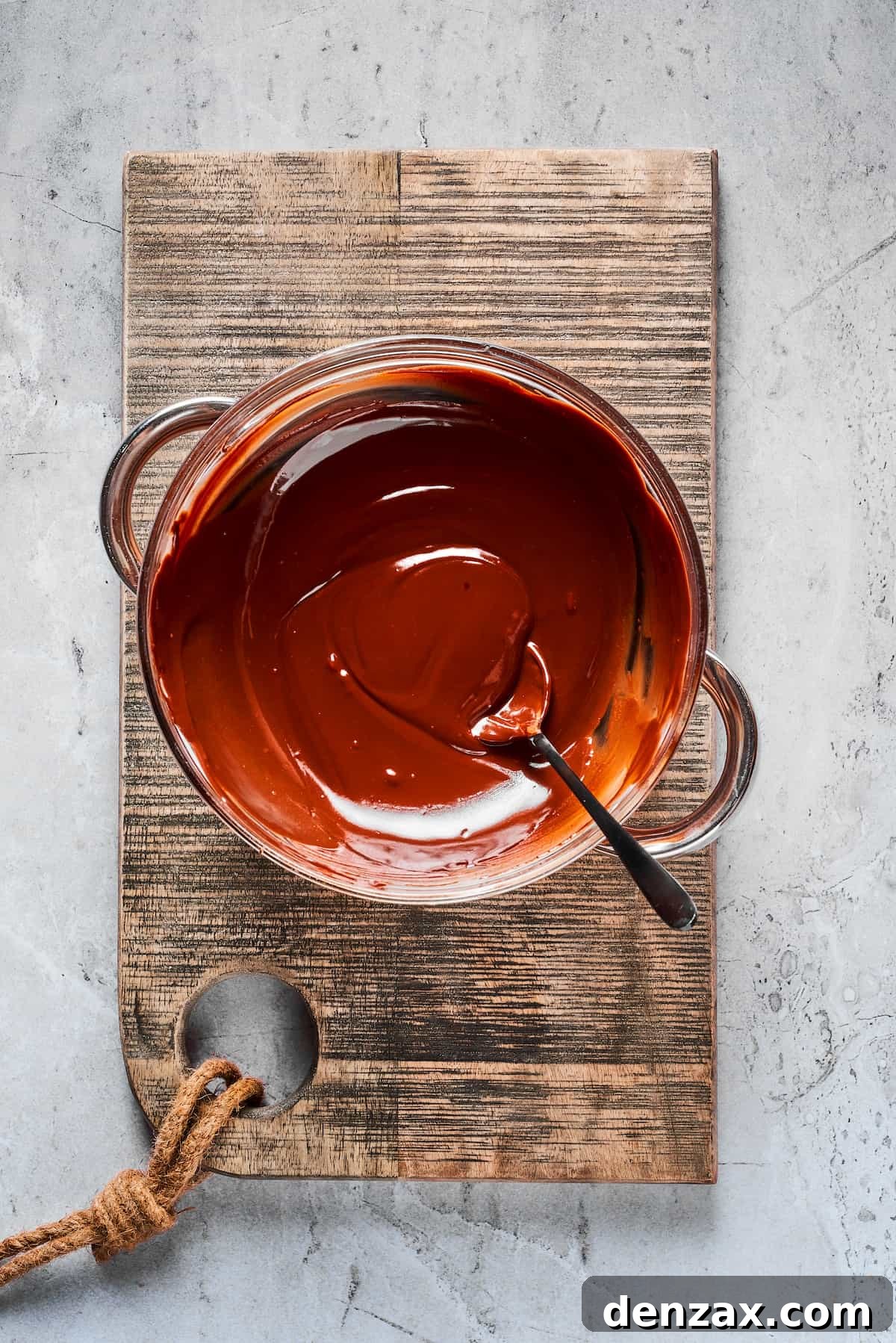 Melted chocolate in a bowl, perfectly smooth and ready for dipping strawberries.