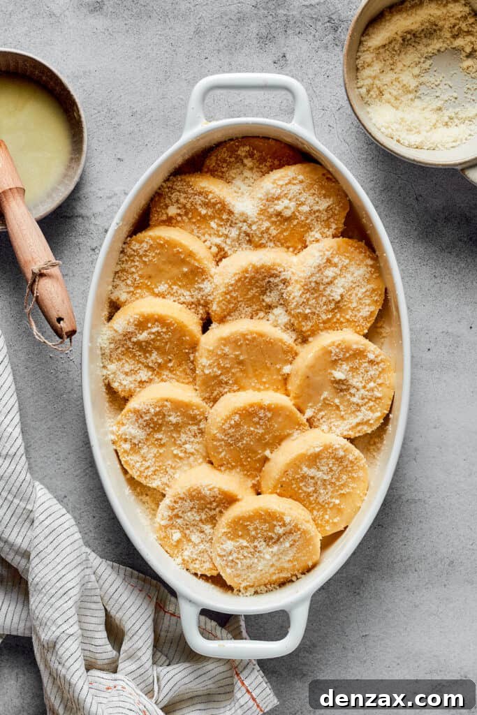 An oval baking dish of gnocchi dusted with parmesan cheese.