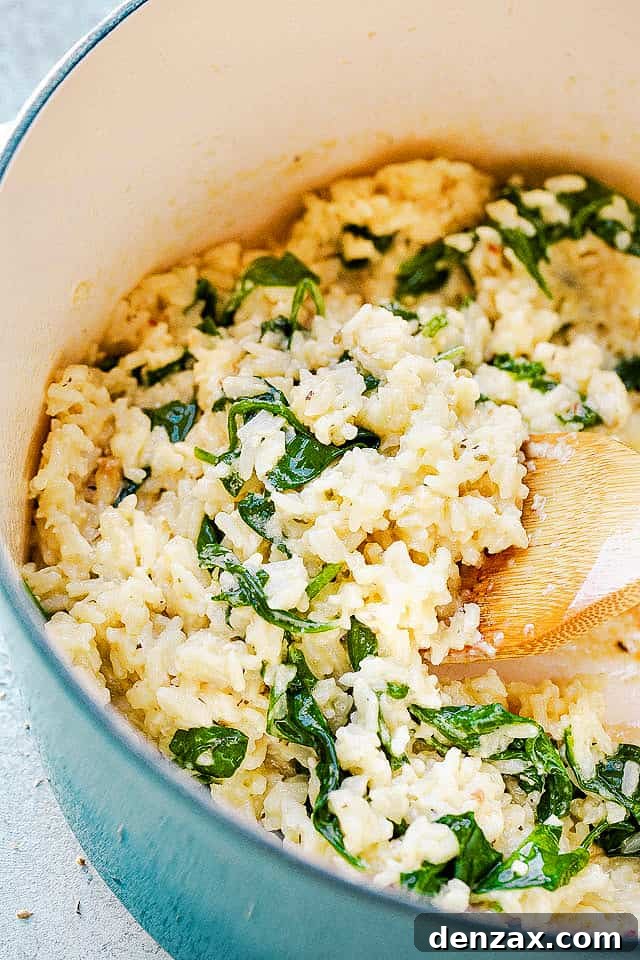 stirring rice and spinach with wooden spoon
