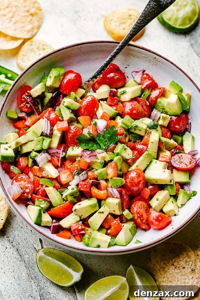 A large salad bowl filled with creamy, chunky avocado salsa, ready to be served.