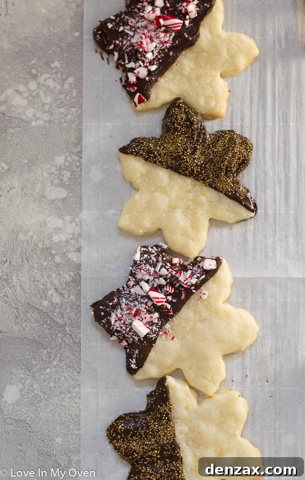 Decadent Chocolate Dipped Shortbread 9 A plate overflowing with various chocolate covered shortbread cookies with festive toppings.
